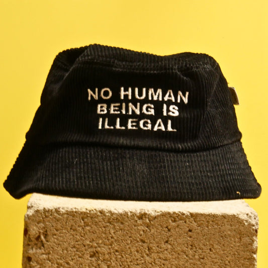 NO HUMAN BEING IS ILLEGAL Bucket Hat